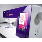 Sewing machine with a digital display and purple control panel on a white background